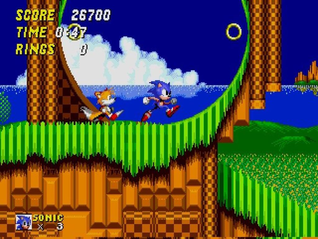 Gameplay from Sonic the Hedgehog 2 showing Sonic and Tails running through a loop in Emerald Hill Zone.